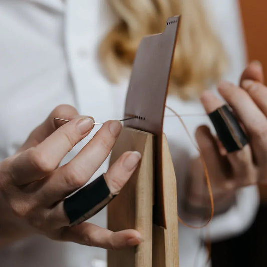 Handsewing leather using a stitching pony