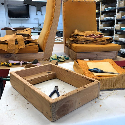 Two armchairs and a footstool dismantled ready for reupholstery