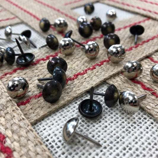 Domed decorative chair nails sitting on jute webbing
