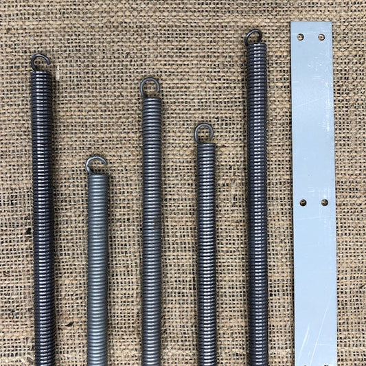 Tension springs and a tension spring trunk plate