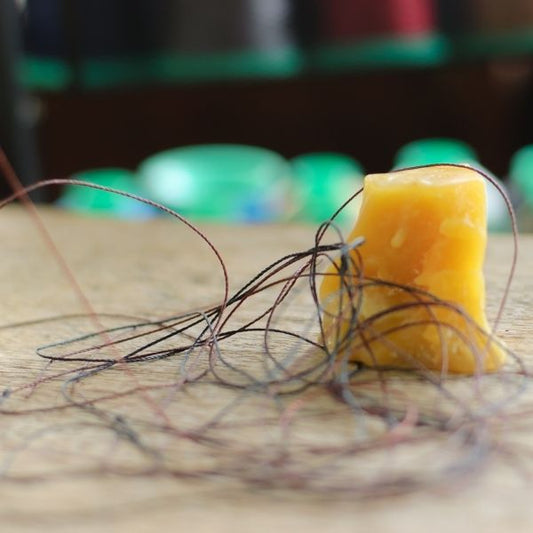 Waxing threads with yellow beeswax