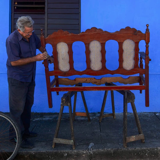 Main repairing a chair on a pair of saw horses