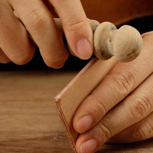 Burnishing edge of leather with wooden slicker