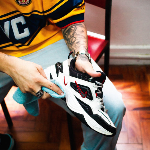 Guy deglazing the finish off a pair of sneakers